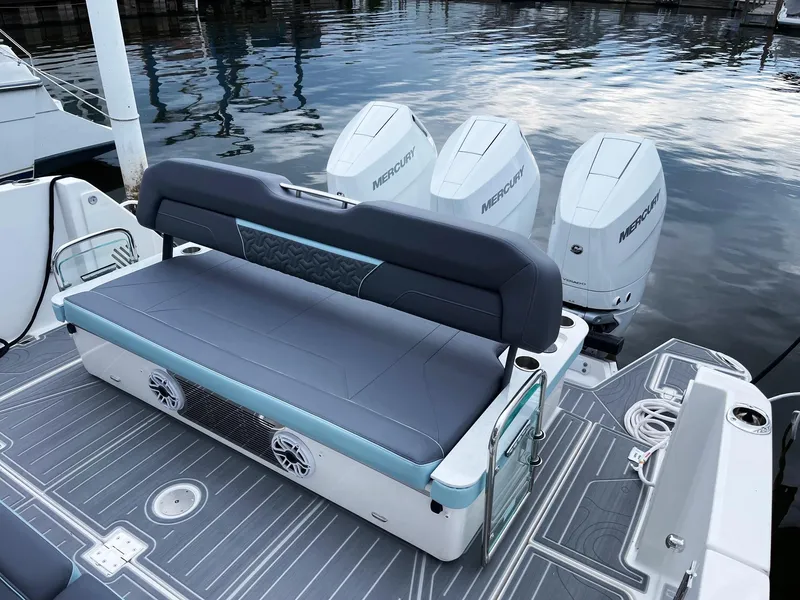 Slide: The Image of 2025 Regal 38 SAV boat with Mercury engines and rear seating at the dock. - 16