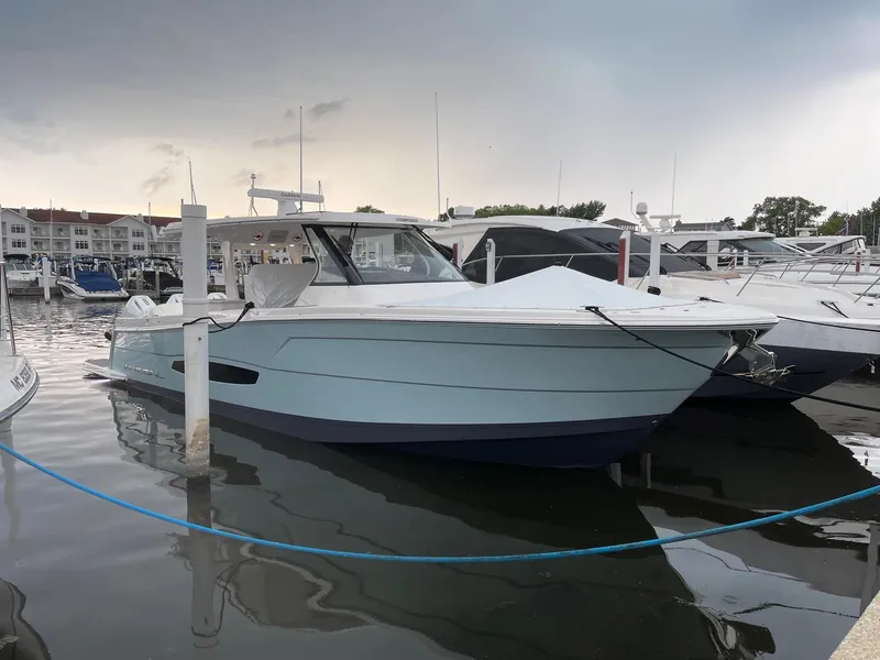 Slide: The Image of 2025 Regal 38 SAV boat docked at marina. - 2