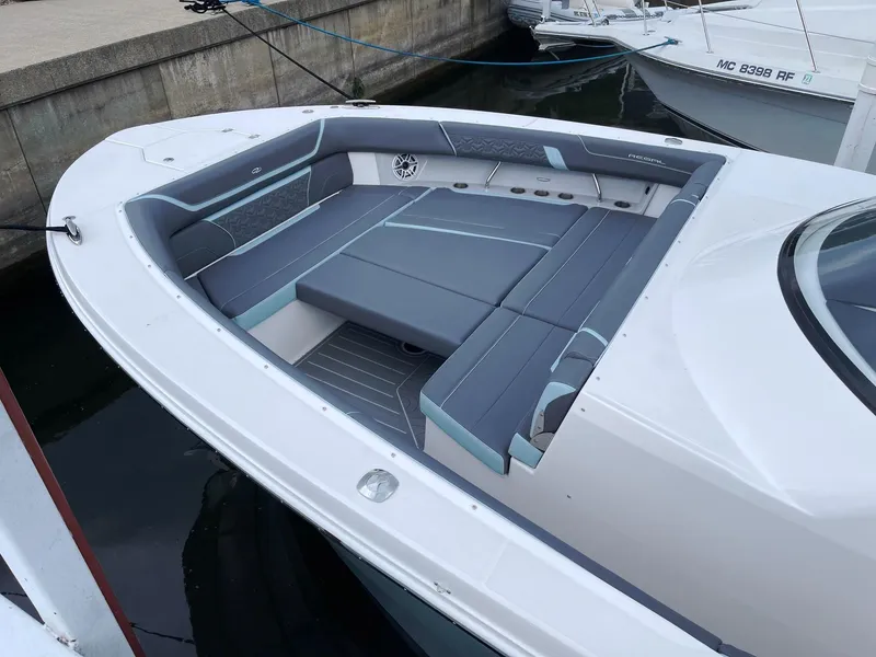 Slide: The Image of 2025 Regal 38 SAV boat with spacious seating area docked in marina. - 20