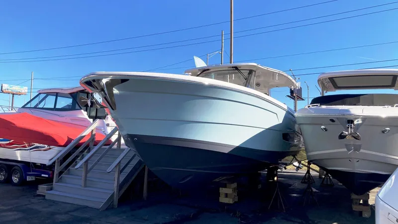 Slide: The Image of 2025 Regal 38 SAV boat displayed outdoors on a sunny day. - 4