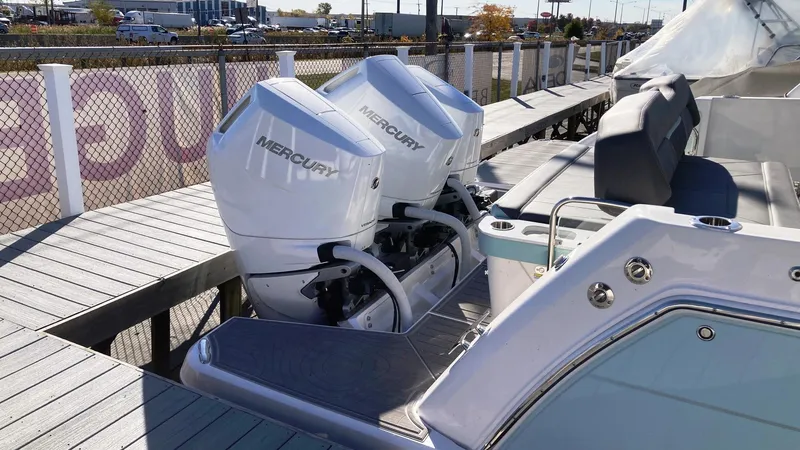 Slide: The Image of 2025 Regal 38 SAV boat with dual Mercury outboard engines docked. - 7