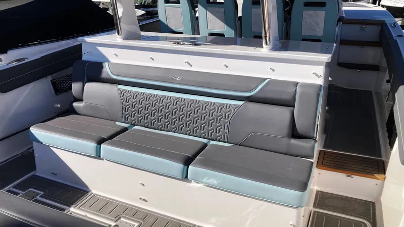 Slide: The Image of 2025 Regal 38 SAV boat interior with stylish gray and blue seating. - 9