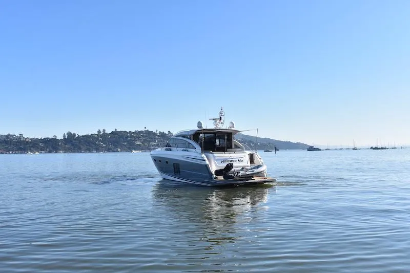 Slide: The Image of 2013 Princess V52 yacht cruising on calm waters under a clear blue sky. - 10