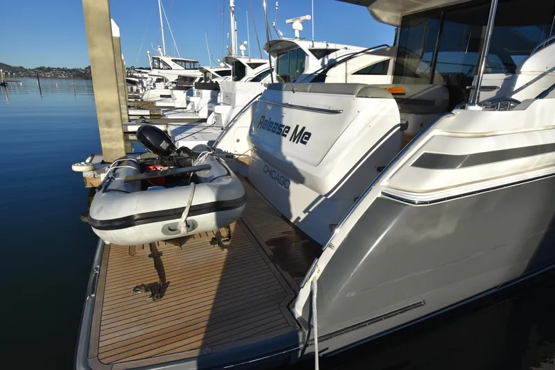 Slide: The Image of 2013 Princess V52 yacht docked with inflatable dinghy on the deck. - 13