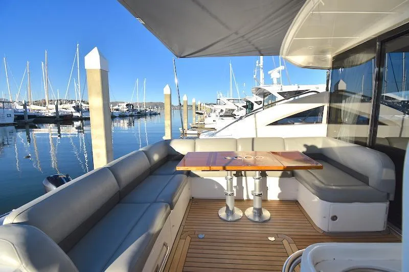 Slide: The Image of 2013 Princess V52 yacht with spacious outdoor seating area at marina. - 16