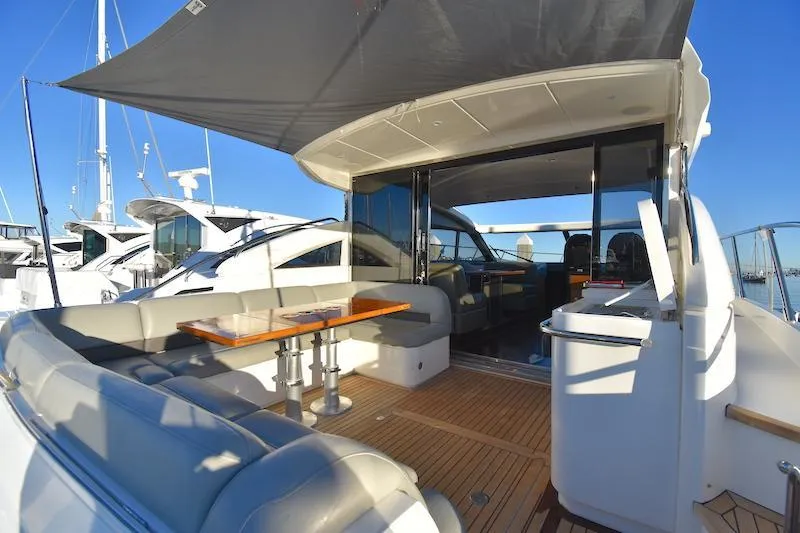 Slide: The Image of 2013 Princess V52 yacht with spacious outdoor seating and dining area. - 18