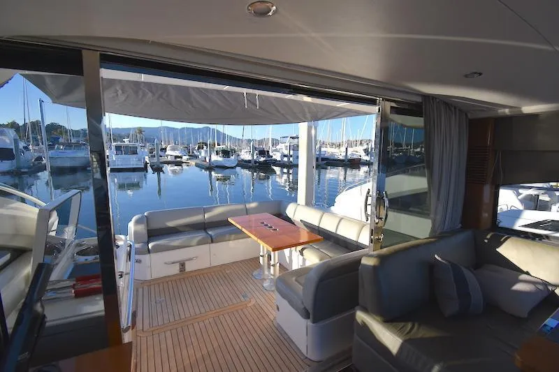 Slide: The Image of Interior view of 2013 Princess V52 yacht with marina backdrop. - 20