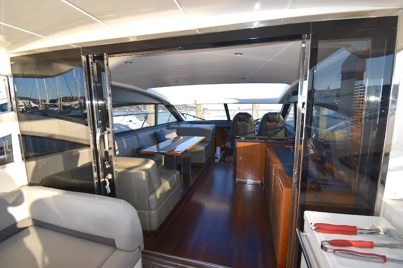 Slide: The Image of Interior view of 2013 Princess V52 yacht with luxurious seating and dining area. - 21