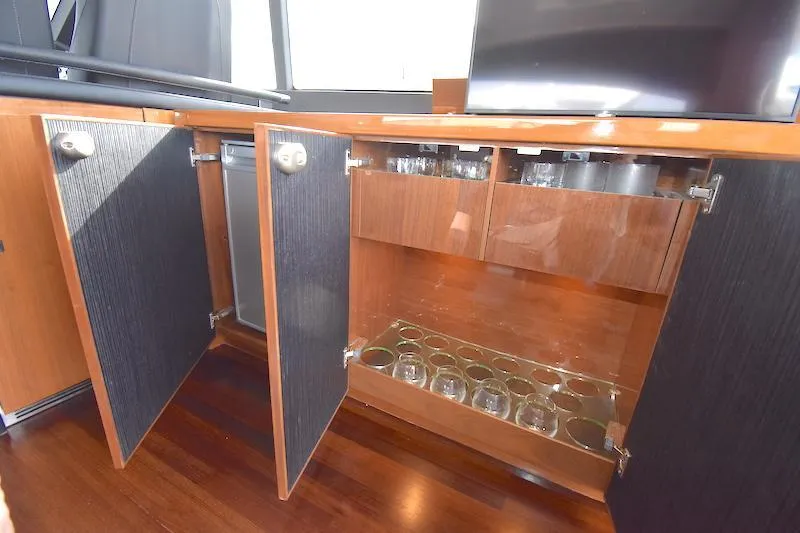 Slide: The Image of Open cabinet with glassware storage on 2013 Princess V52 yacht. - 25