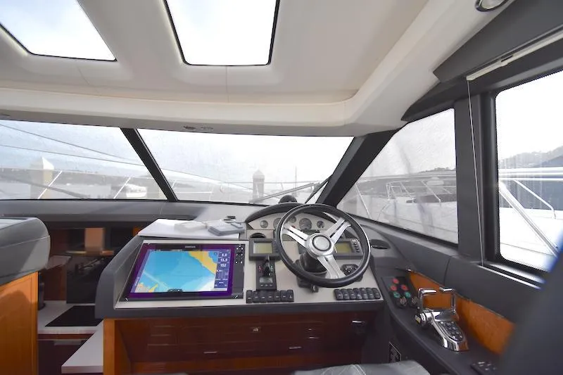 Slide: The Image of Interior helm of 2013 Princess V52 yacht with navigation system and steering wheel. - 29