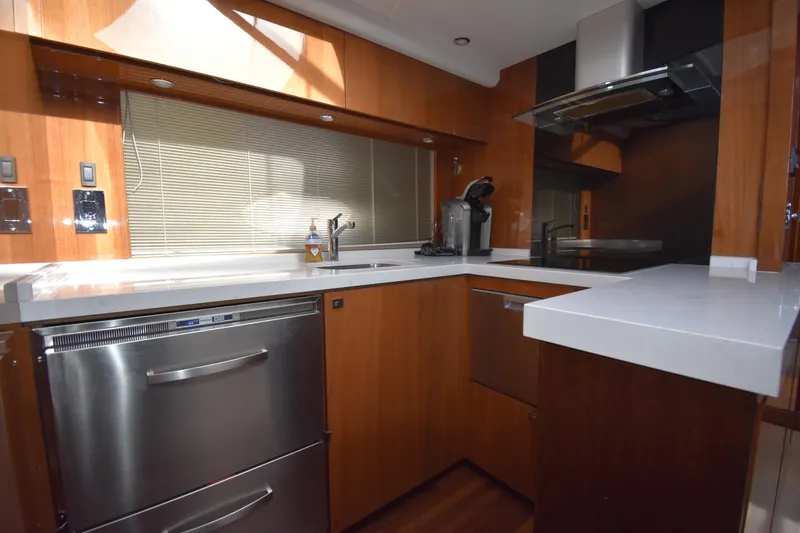 Slide: The Image of Modern kitchen in 2013 Princess V52 yacht with stainless steel appliances and wooden cabinetry. - 32