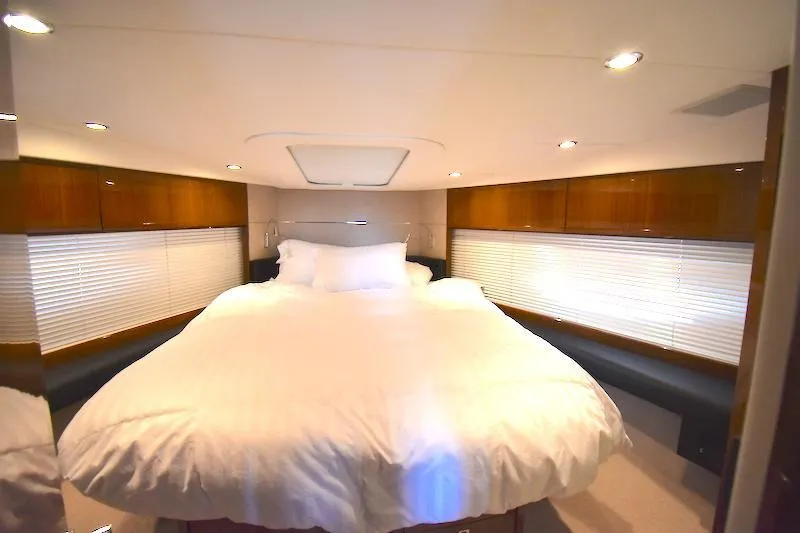 Slide: The Image of Luxurious bedroom in a 2013 Princess V52 yacht with a cozy bed and modern lighting. - 37