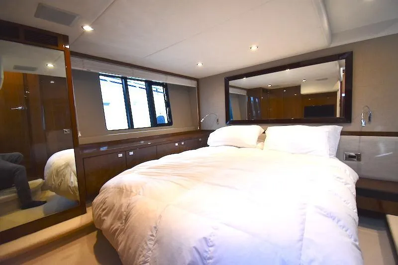 Slide: The Image of Luxurious bedroom interior of 2013 Princess V52 yacht with elegant furnishings and large mirror. - 42