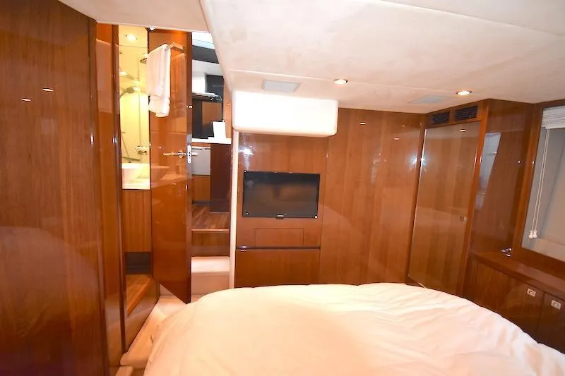 Slide: The Image of Luxurious interior of 2013 Princess V52 yacht cabin with wood paneling and TV. - 43