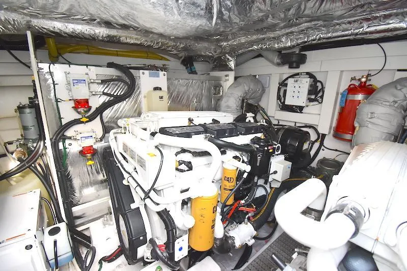 Slide: The Image of Engine room of a 2013 Princess V52 yacht, showcasing mechanical components and equipment. - 48