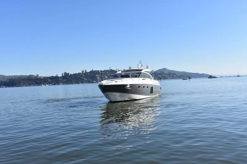 Slide: The Image of 2013 Princess V52 yacht cruising on a calm, scenic lake. - 6