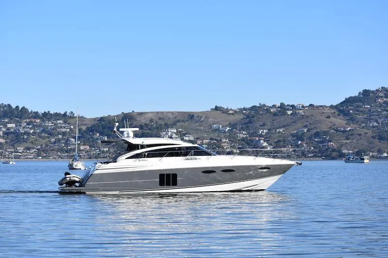 Slide: The Image of 2013 Princess V52 yacht cruising on a calm lake with scenic hills in the background. - 66