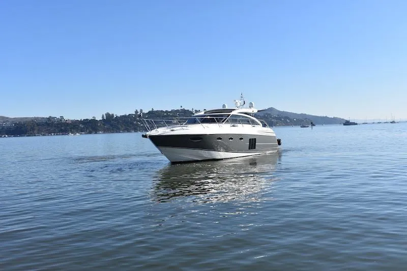 Slide: The Image of 2013 Princess V52 yacht cruising on calm waters with scenic background. - 7