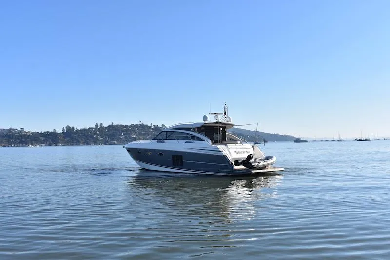 Slide: The Image of 2013 Princess V52 yacht cruising on calm waters under a clear blue sky. - 70