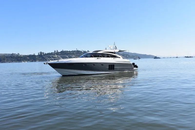 Slide: The Image of 2013 Princess V52 yacht cruising on calm waters under clear blue sky. - 8