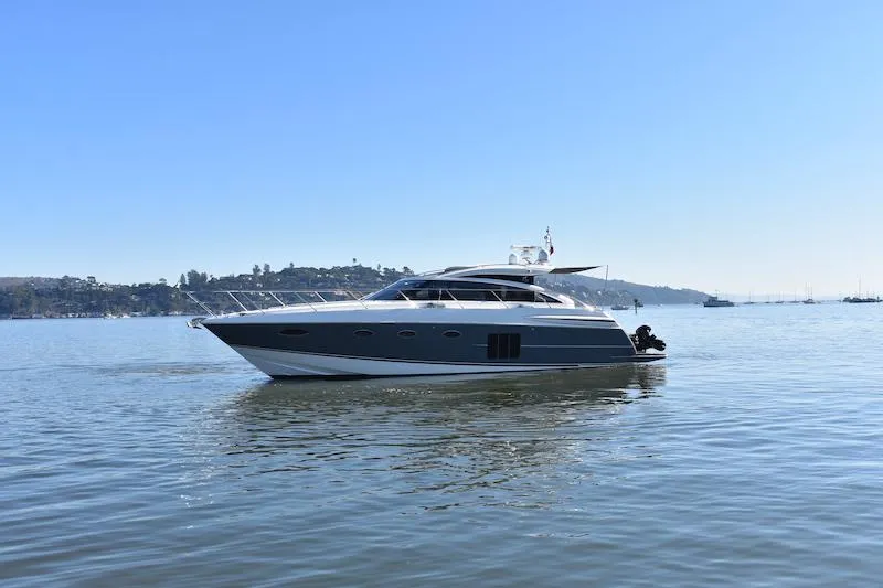 Slide: The Image of 2013 Princess V52 yacht cruising on calm waters under a clear blue sky. - 9