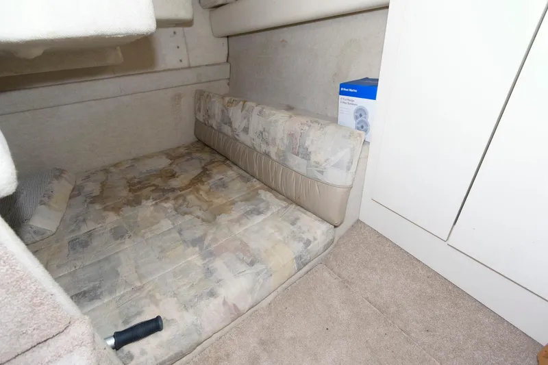 Slide: The Image of 1998 Bayliner 2855 Ciera cabin interior with bed and storage space. - 11