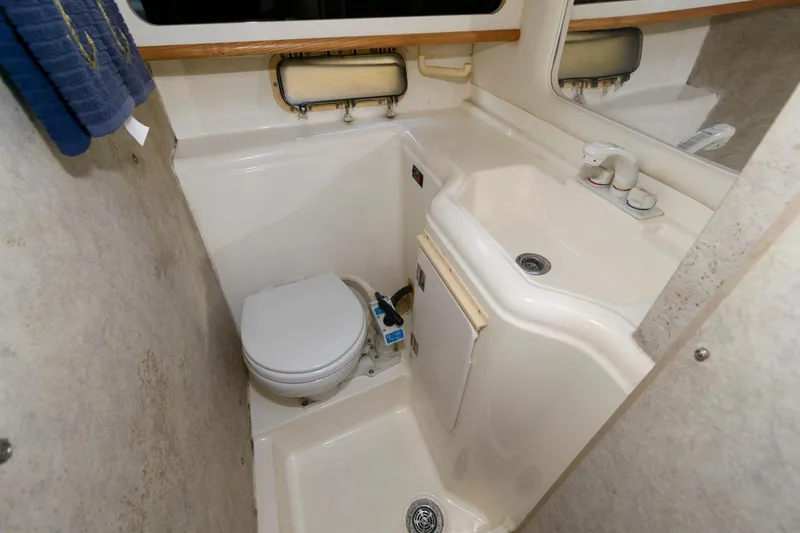 Slide: The Image of 1998 Bayliner 2855 Ciera boat bathroom with toilet, sink, and mirror. - 12