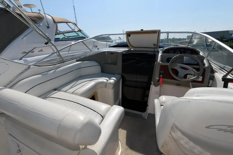 Slide: The Image of 1998 Bayliner 2855 Ciera boat interior with white seating and steering wheel. - 2
