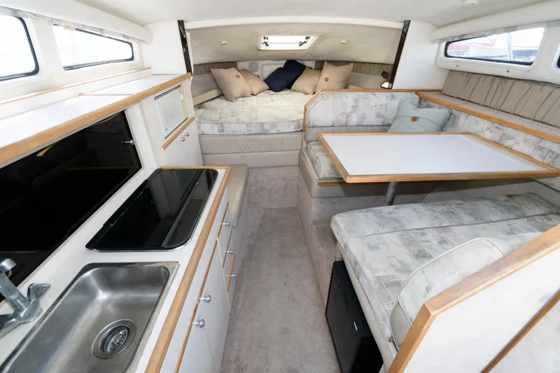 Slide: The Image of Interior of 1998 Bayliner 2855 Ciera with kitchen, dining area, and sleeping quarters. - 6