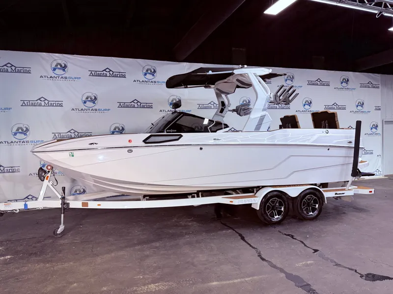 Slide: The Image of 2024 Supra SL 400 boat on trailer in showroom. - 13