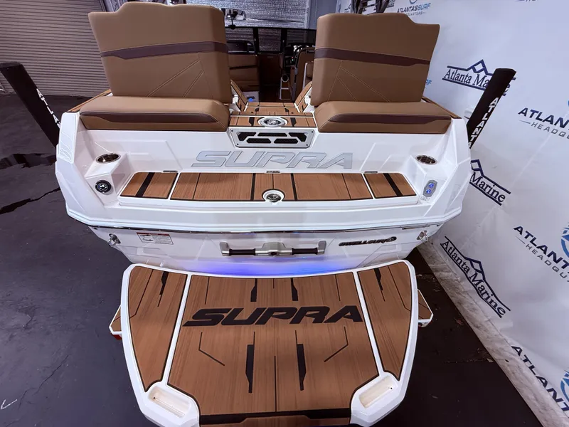 Slide: The Image of Rear view of 2024 Supra SL 400 boat with wood paneling. - 16