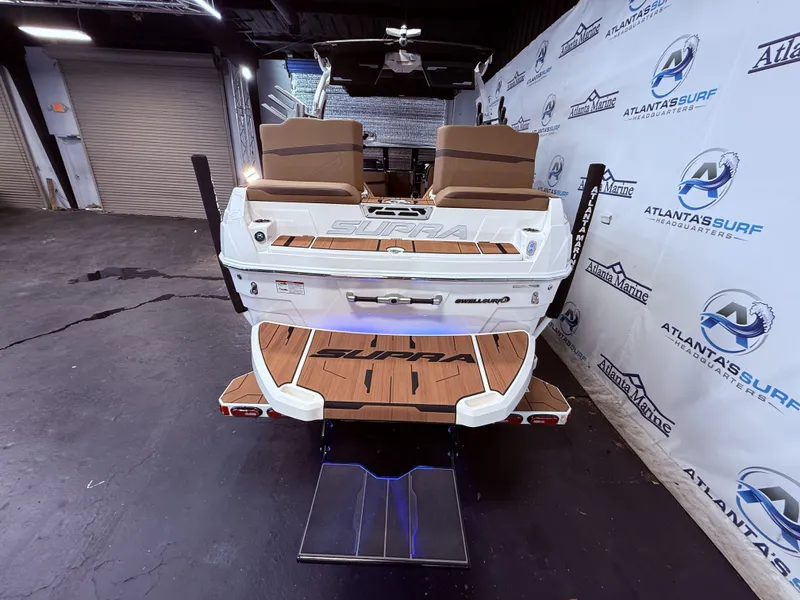 Slide: The Image of Rear view of 2024 Supra SL 400 boat in a showroom. - 28