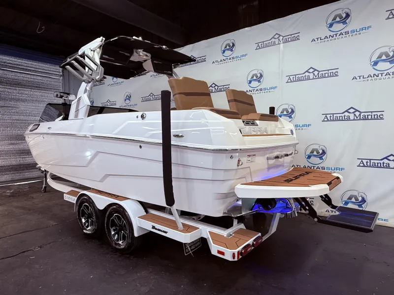 Slide: The Image of 2024 Supra SL 400 boat on trailer in showroom. - 3