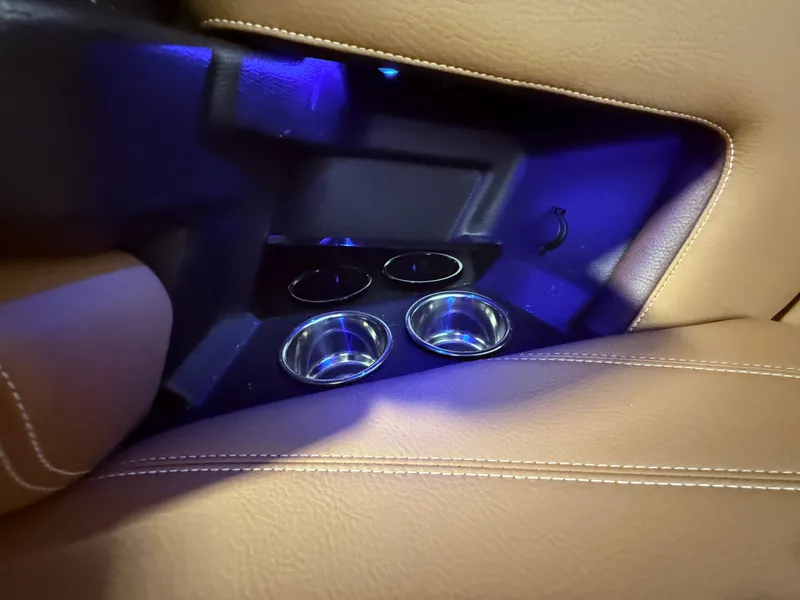 Slide: The Image of Interior of 2024 Supra SL 400 with illuminated cup holders. - 39