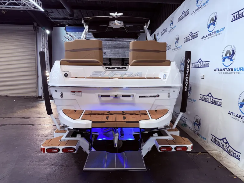 Slide: The Image of Rear view of 2024 Supra SL 400 boat in showroom. - 5