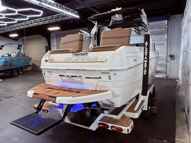 Slide: The Image of 2024 Supra SL 400 boat in showroom with modern design. - 6