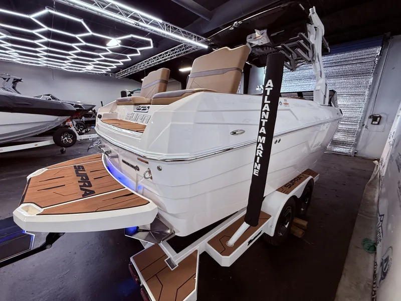 Slide: The Image of 2024 Supra SL 400 boat in showroom with modern design. - 7