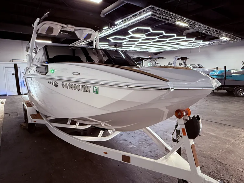 Slide: The Image of 2024 Supra SL 400 boat in an indoor showroom. - 8