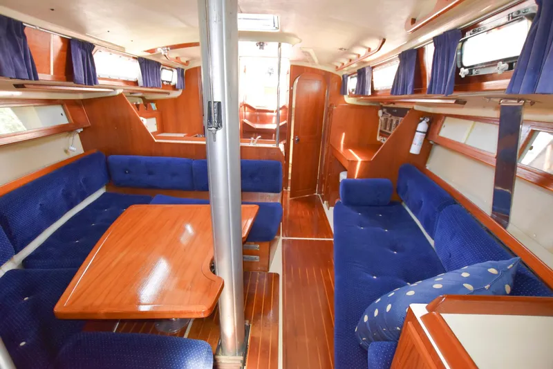Slide: The Image of Interior of a 1985 Pearson 36-2 sailboat with blue upholstery and wooden finishes. - 17