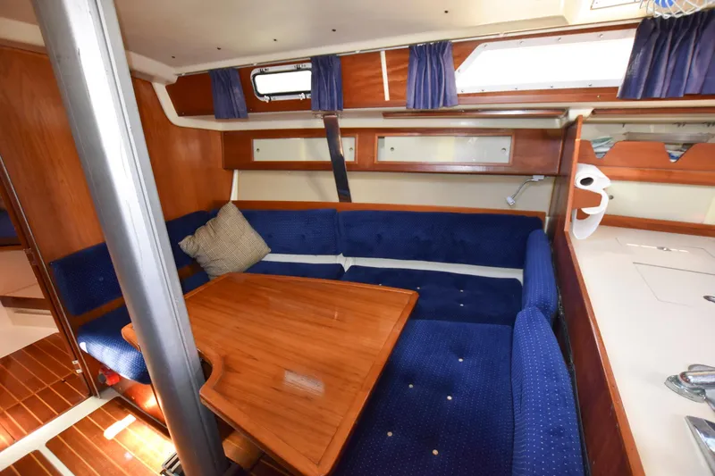 Slide: The Image of Interior of 1985 Pearson 36-2 sailboat with blue upholstery and wooden table. - 19