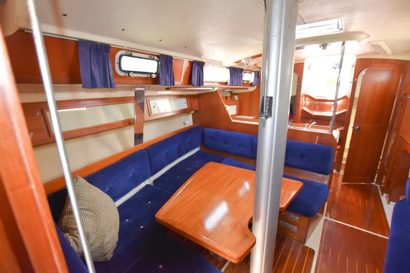 Slide: The Image of Interior of 1985 Pearson 36-2 sailboat with blue seating and wooden table. - 20