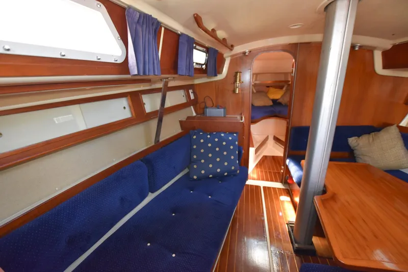 Slide: The Image of Interior of 1985 Pearson 36-2 sailboat with blue upholstery and wooden finishes. - 23