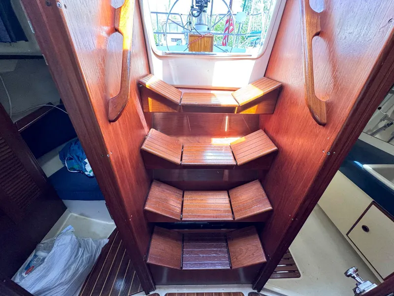 Slide: The Image of Wooden steps leading to the deck of a 1985 Pearson 36-2 sailboat. - 27