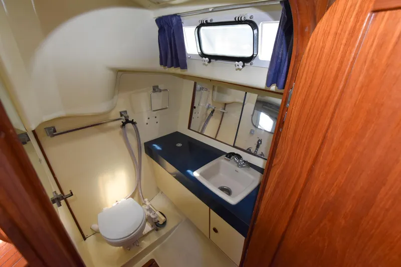 Slide: The Image of 1985 Pearson 36-2 sailboat bathroom with sink, toilet, and mirror. - 28