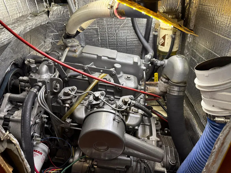 Slide: The Image of Engine compartment of a 1985 Pearson 36-2 sailboat with visible hoses and wiring. - 29