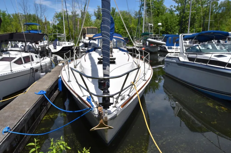 Slide: The Image of 1985 Pearson 36-2 sailboat docked at a marina, surrounded by other boats. - 3
