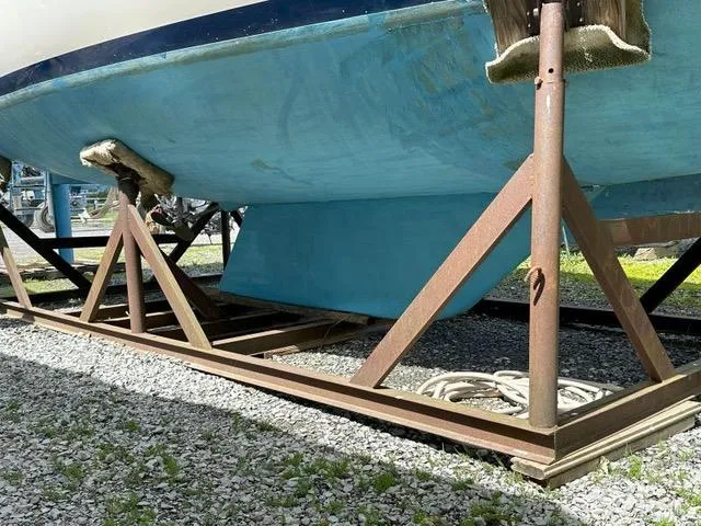 Slide: The Image of 1985 Pearson 36-2 sailboat hull on metal stands, gravel ground. - 31