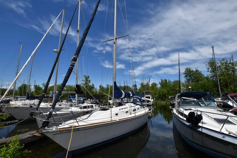 Slide: The Image of Sailboats docked at a marina, featuring a 1985 Pearson 36-2 under a clear blue sky. - 4