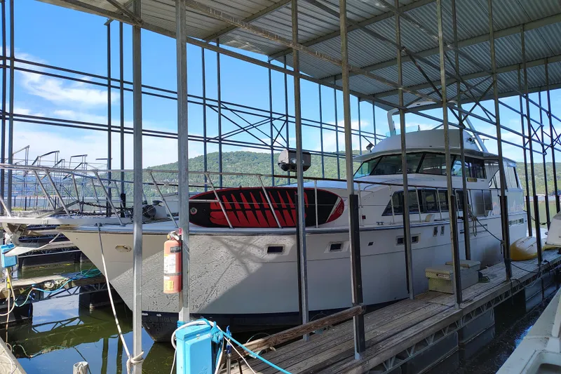 The Image of 1976 Bertram 58 Flybridge Motor Yacht docked in a covered marina. - 0