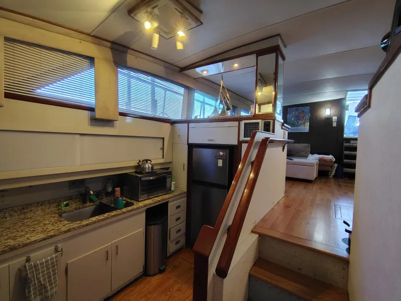 Slide: The Image of Interior of 1976 Bertram 58 Flybridge Motor Yacht with kitchen and living area. - 14